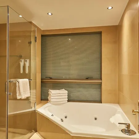 Plaza El Bosque Ebro Hotel Santiago Exterior photo A shower and bathtub in a hotel
